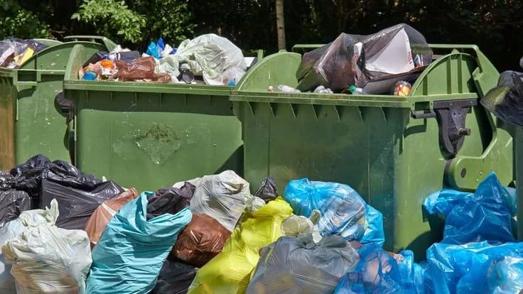 Roll-off dumpster loaded with cleanout and construction debris at a job site (20)