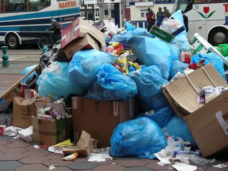 Roll-off dumpster loaded with cleanout and construction debris at a job site (21)