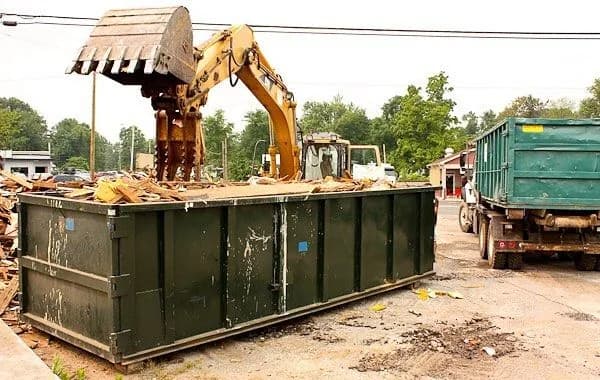 Roll-off dumpster loaded with cleanout and construction debris at a job site (22)