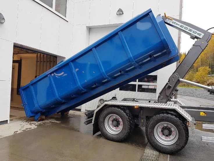 Roll-off dumpster loaded with cleanout and construction debris at a job site (23)