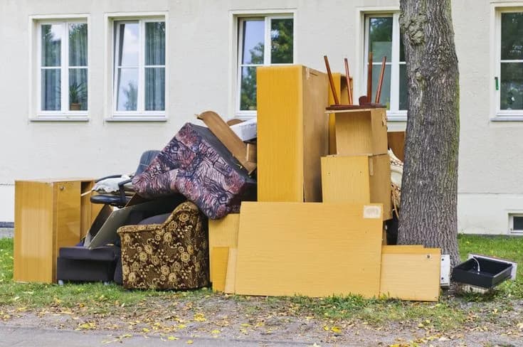 Roll-off dumpster loaded with cleanout and construction debris at a job site (24)