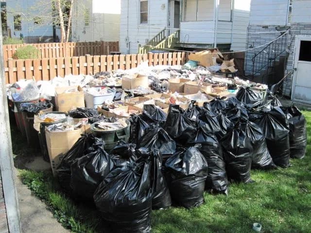 Roll-off dumpster loaded with cleanout and construction debris at a job site (25)