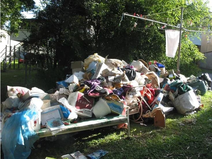 Roll-off dumpster loaded with cleanout and construction debris at a job site (28)
