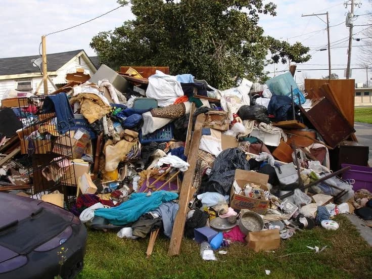 Roll-off dumpster loaded with cleanout and construction debris at a job site (29)