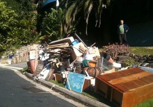 Roll-off dumpster loaded with cleanout and construction debris at a job site (32)