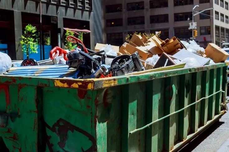 Roll-off dumpster loaded with cleanout and construction debris at a job site (33)
