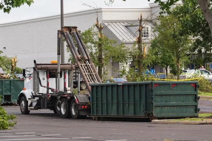 Roll-off dumpster loaded with cleanout and construction debris at a job site (34)
