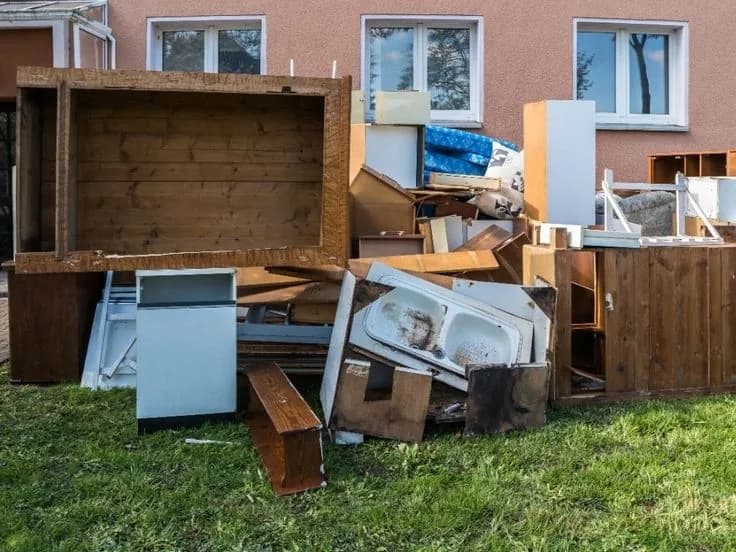 Roll-off dumpster loaded with cleanout and construction debris at a job site (35)
