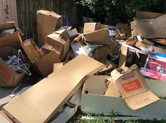 Roll-off dumpster loaded with cleanout and construction debris at a job site (36)