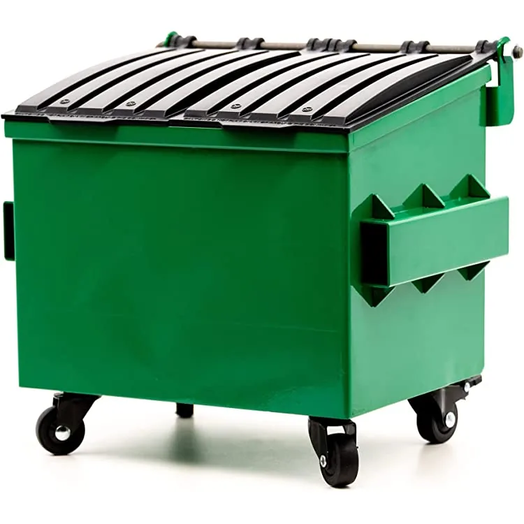 Green roll-off dumpster delivered and staged on a driveway, ready to load